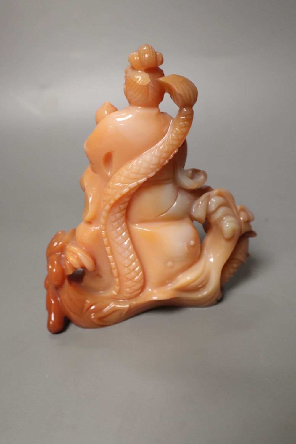 A Chinese chalcedony carving of Guanyin and a dragon, 13.5cm high